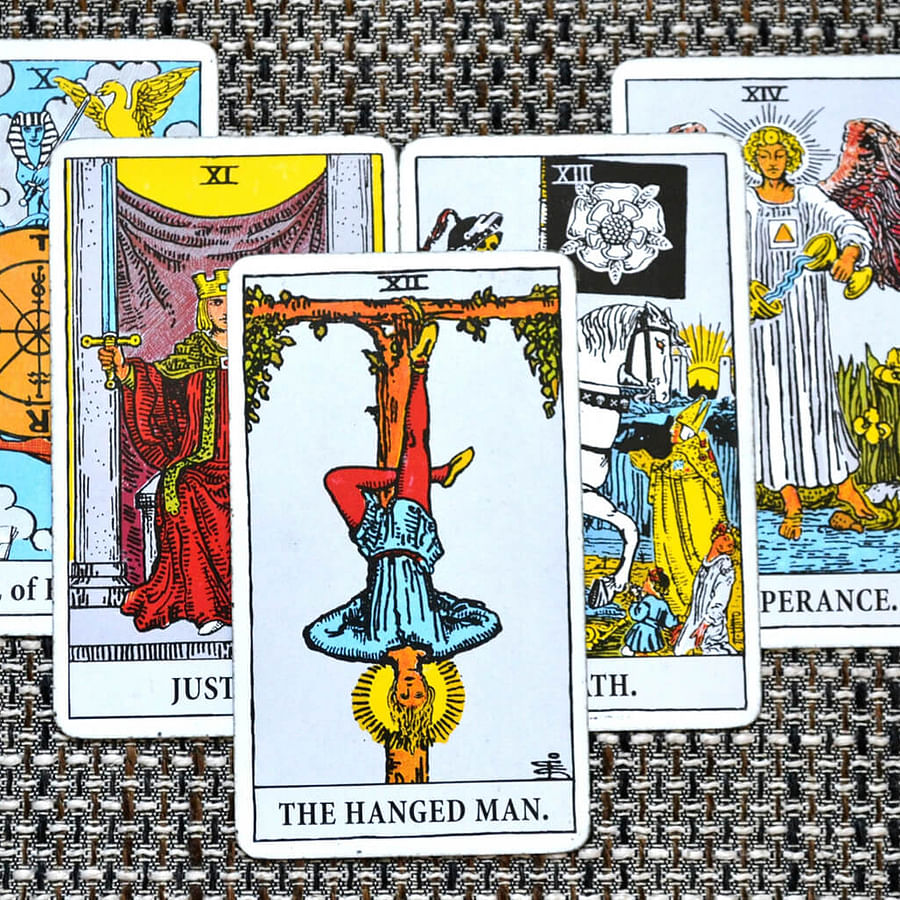 Close-up view of the Hanged Man tarot card highlighting key symbols